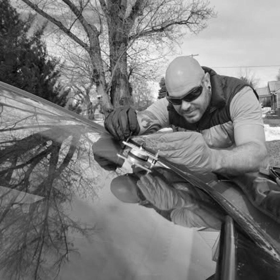 Emmett repairing a windshield rock chip with a resin injector